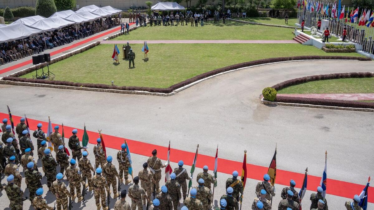 Peacekeepers standing in a line are photographed from above.