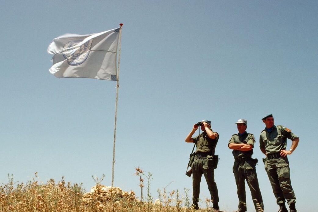 Peacekeepers watch out from a hill.