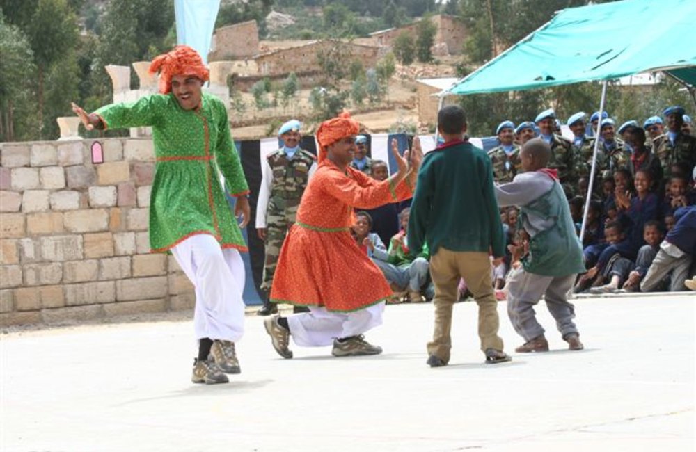 Schoolchildren join peacekeepers in a traditional  Indian dance (Photo: Ian Steele)